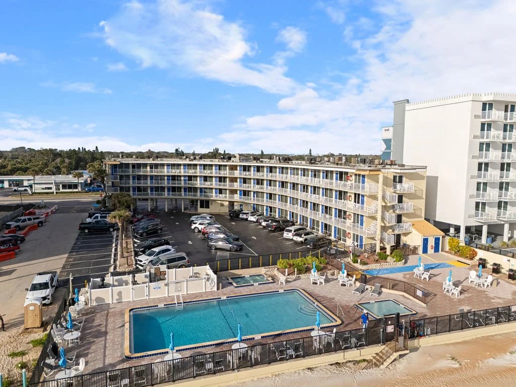 Beachfront hotel with a large outdoor pool and ocean views.
